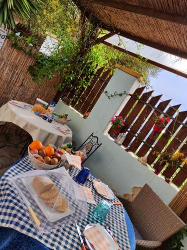 a table with a bowl of fruit on top of it at La Pirata Capitana in Costa degli Angeli