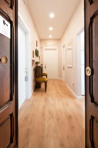 an empty hallway with a table and a chair in a room at Casa Lina in Civitavecchia
