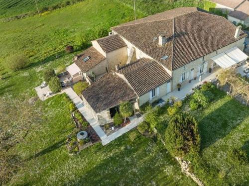 an overhead view of a large house with a roof at Le Mas Réolais in Saint-Sève