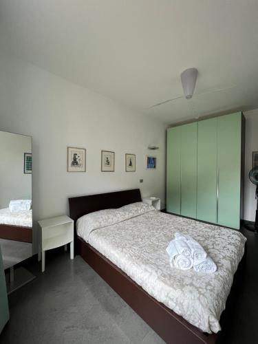 a bedroom with a bed and a green cabinet at Casa Costanza in Maiori