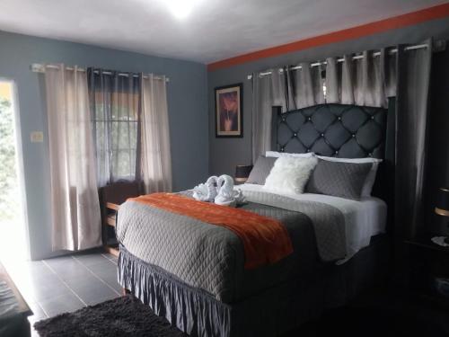 a bedroom with a bed with a stuffed animal on it at Tashari-dae Inn king suite in Mandeville