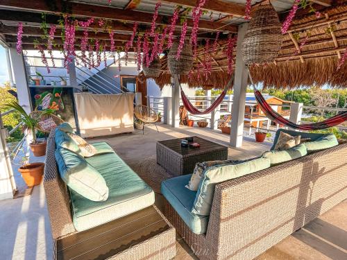 a patio with two wicker chairs and a table at Costa Nube in Caye Caulker