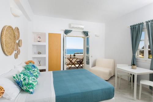 a bedroom with a bed and a view of the ocean at La Mer Seaside Apartments in Drios