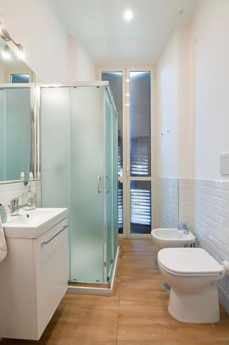 a bathroom with a shower and a toilet and a sink at Casa Lina in Civitavecchia