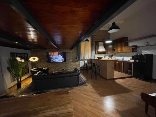 a living room with a couch and a kitchen at Residence Bruno in Foggia