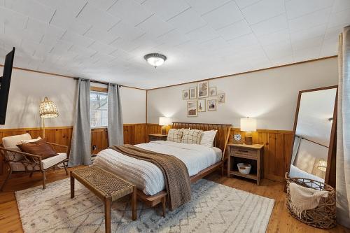 a bedroom with a bed and a table and a chair at Mountainscape Cabins 1 in Thornton