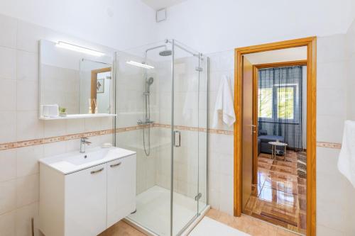 a bathroom with a shower and a sink at Apartman Mia in Pula