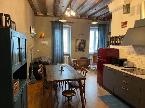 a kitchen with a table and a dining room at Santorio 5 Apartment in Trieste