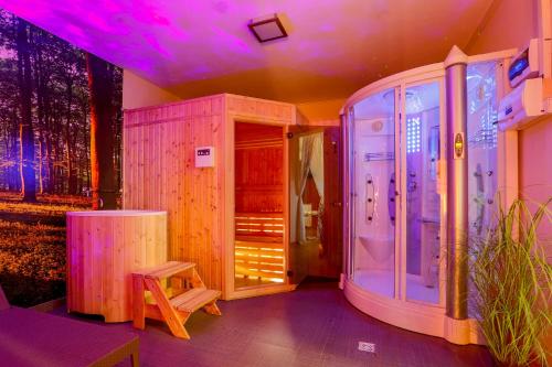 a room with a sauna with a bench and purple lighting at Wellness Apartmány Fatrapark 1 Malinô Brdo in Ružomberok