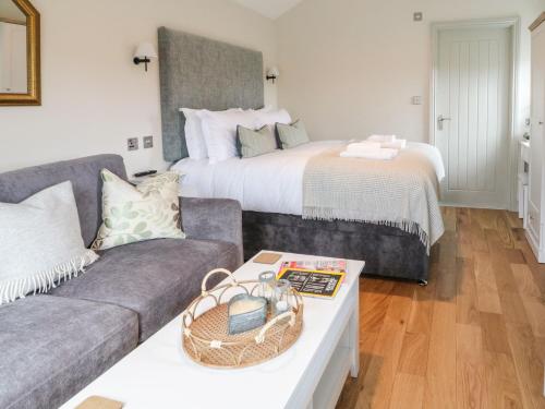 a living room with a couch and a bed at The Folly in Skipton