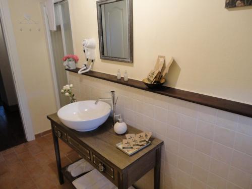 a bathroom with a sink and a mirror at Casa Shalom in Pennabilli