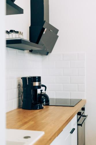 a kitchen with a counter top with a coffee maker at Apartament Marbud 2 przy Aquaparku Reda in Rumia