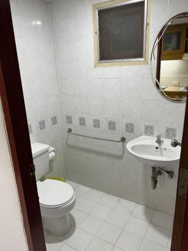 a bathroom with a toilet and a sink at Mall Suites Hotel in Bangkok