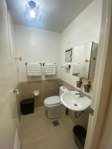 a small bathroom with a toilet and a sink at 1 BR Condo Unit at The Celandine Condominium near Ayala Cloverleaf Mall in Manila