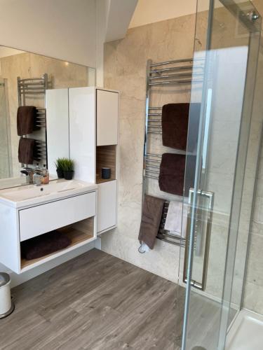 a bathroom with a white sink and a shower at The Stable Yard @ Manor Bank Cottage in Beaulieu