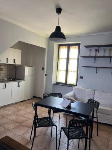 a living room with a table and chairs and a couch at Host Civico 4 in Montafia