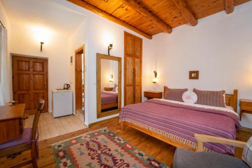 A bed or beds in a room at Watermill Villa & Hotel Faralya