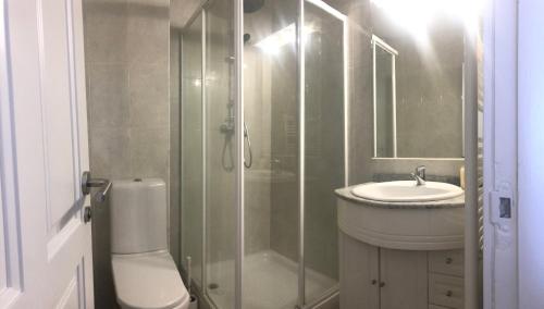 a bathroom with a shower and a toilet and a sink at Apartamento Comillas Beach in Comillas