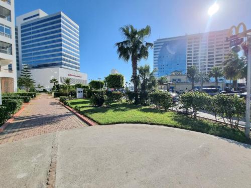 a park in the middle of a city with tall buildings at Tanger Malabata in Tangier