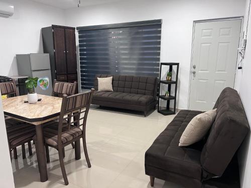 a living room with a couch and a table at Departamento 103 in Mazatlán