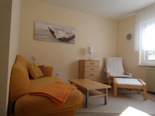 a living room with a couch and a table at Holiday Home Martina in Dresden