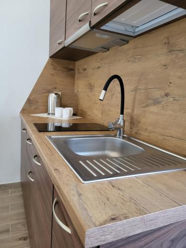 a kitchen with a sink in a wooden counter top at DERCÓWKA in Mieroszyno