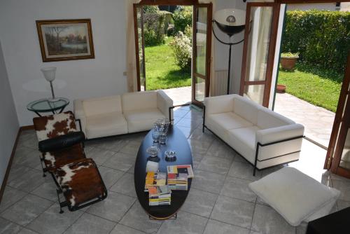 a living room with a couch and a table and chairs at Villa Luisa Design in Colle Val D'Elsa