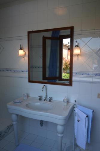 a bathroom with a sink and a mirror at Villa Luisa Design in Colle Val D'Elsa