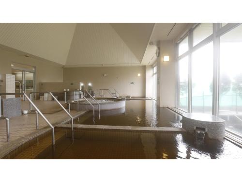 a large room with a pool of water in a building at Japanese Auberge Plaza Ryokufu Natural Hot Spring - Vacation STAY 03209v in Shimo-orube