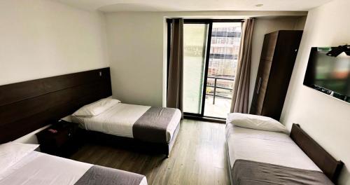 Postel nebo postele na pokoji v ubytování Hotel Expo Hotel Ferial
