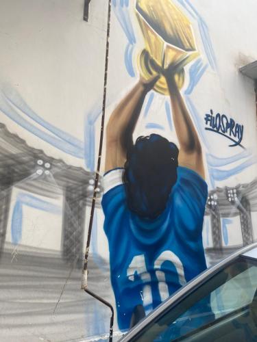 a painting of a man holding a sign on a wall at Casa dolce casa in Naples