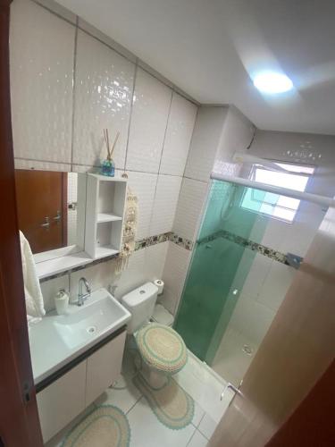 a bathroom with a shower and a toilet and a sink at Apartamento Ideal Flores in Manaus