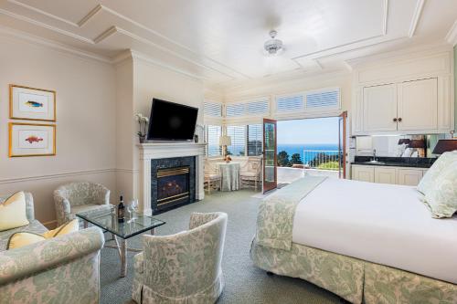 a bedroom with a large bed and a fireplace at Tally Ho Inn in Carmel