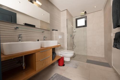 a bathroom with a sink and a toilet at Villa 10 Palmeraie Golf Agadir in Agadir