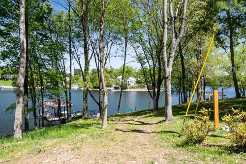 a view of a lake with trees and a house at New Home, Dock, Home Theatre Projector, Hot Tub, Fire Pit, Kayaks in Winchester