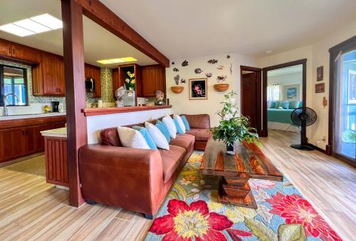 a living room with a couch and a table at Ocean View Black Sand Beach House @ Kehena beach HI in Pahoa