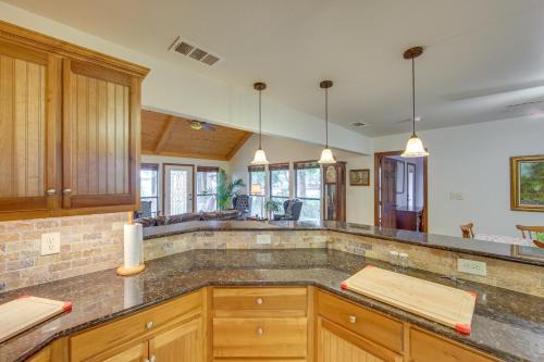 a kitchen with wooden cabinets and a counter top at Wills Point Vacation Rental on 10 Acres of Land! in Canton