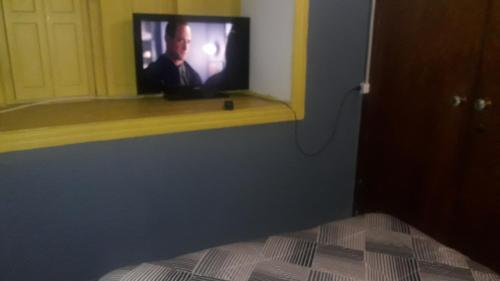 a television sitting on a window sill in a bedroom at Hostería Residencial Santa Rosa in Los Andes