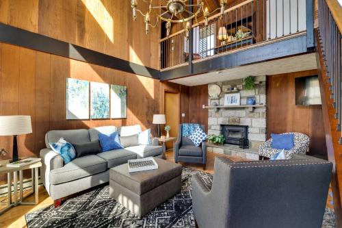 a living room with a couch and a fireplace at Dock and Fire Pit Lakefront Poconos Retreat! in Long Pond