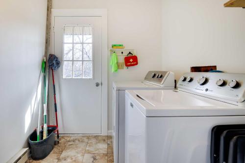 a kitchen with a white sink and a stove at Dock and Fire Pit Lakefront Poconos Retreat! in Long Pond