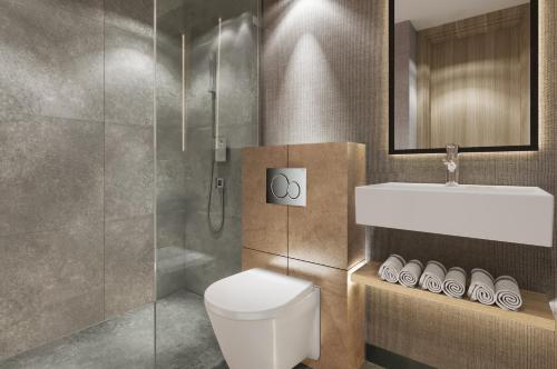 a bathroom with a toilet and a sink and a shower at Erzurumlu Hotel in Kilyos