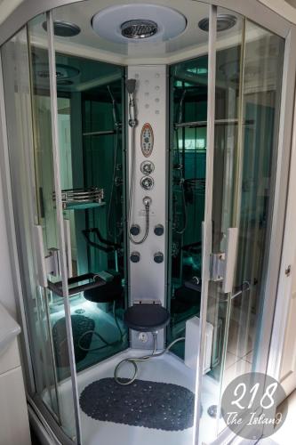 a bathroom with a shower with a toilet in it at The Cabin, Glan Gwna in Caernarfon