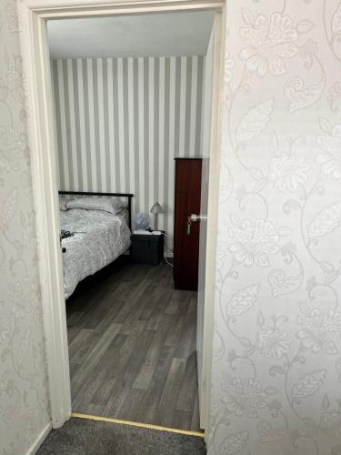 a bedroom with a bed and a door leading into a room at MACs Belfast in Belfast