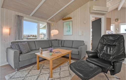 a living room with a couch and a table at Cozy Home In Haderslev With Sauna in Haderslev