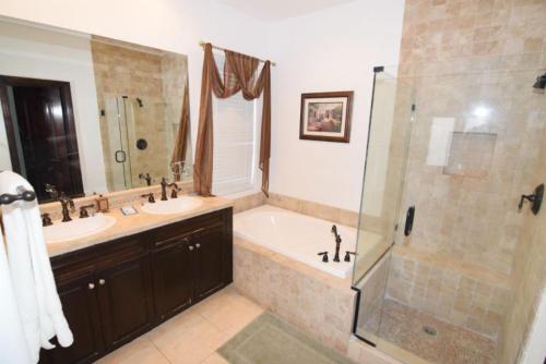 a bathroom with two sinks and a tub and a shower at Condo 19-3 Family Vacation Condo on the Sea of Cortez pools tennis and golf in Playa El Paraíso