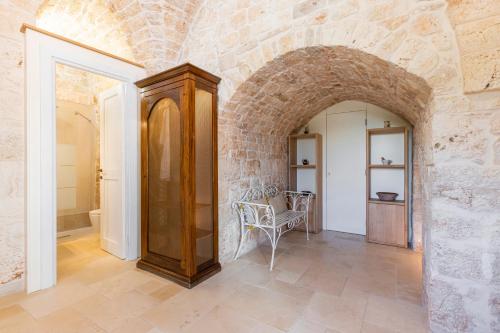 a hallway with an archway in a stone wall at Le Casette in Gravina Luxury in Villa Castelli
