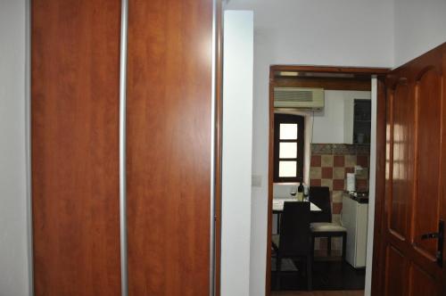 a hallway with a wooden door and a kitchen at Apartments Vujošević in Kotor