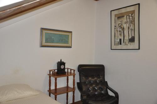 a bedroom with a bed and a chair and a table at Apartments Vujošević in Kotor