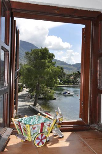 a window with a view of a river and a bike outside at Apartments Vujošević in Kotor