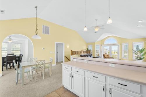 a kitchen and dining room with a table and chairs at Sound Happy in Rodanthe